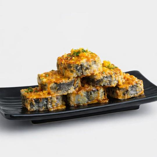 Godzilla roll on a black plate